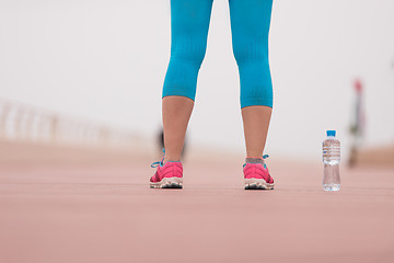 Image showing close up on running shoes and bottle of water