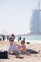 Image showing Mom and daughter on the beach