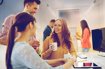 Image showing happy creative team drinking coffee at office