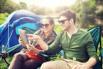 Image showing happy couple with tablet pc at camping tent