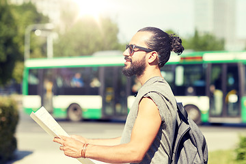 Image showing man traveling with backpack and map in city