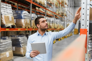 Image showing businessman with tablet pc at warehouse