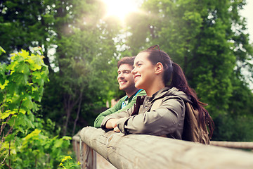 Image showing smiling couple with backpacks in nature