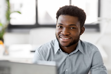 Image showing african american businessman with laptop at office