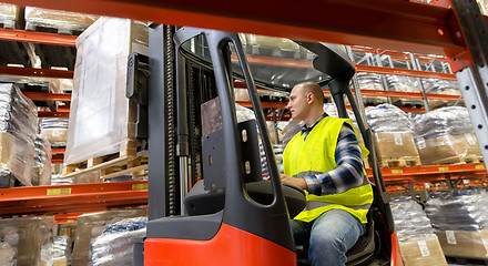 Image showing loader operating forklift at warehouse