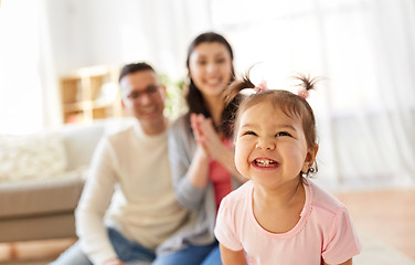 Image showing happy baby girl and parents at home