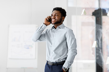 Image showing businessman calling on smartphone at office