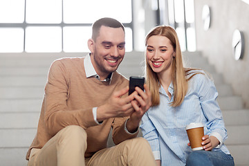 Image showing man and woman with smartphone at office stairs