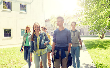 Image showing group of happy teenage students walking outdoors