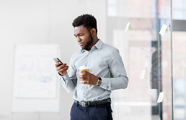 Image showing businessman with smartphone and coffee at office