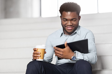 Image showing businessman with tablet pc and coffee on stairs