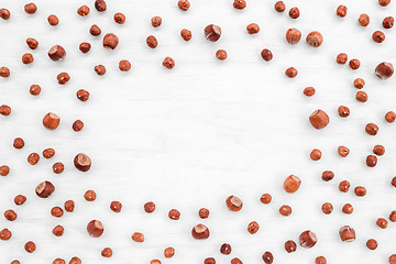 Image showing Hazelnuts on white wooden background with copy space