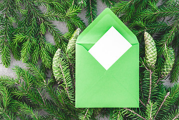 Image showing Fir branches and green envelope with blank greeting card