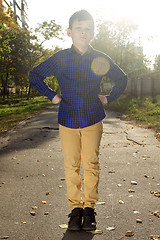 Image showing Happy boy have fun in the autumn park