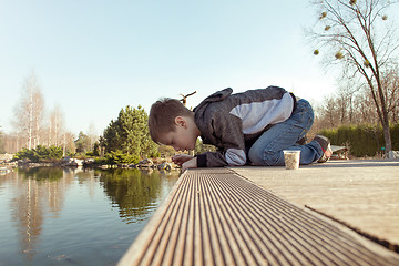 Image showing Boy in the park by the lake