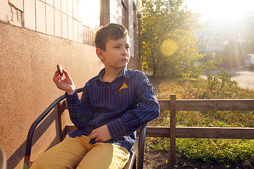 Image showing Boy eating sweets