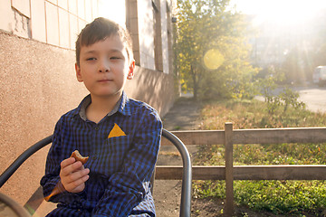 Image showing Boy eating sweets