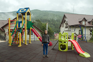 Image showing Boy on the playground near the mountains