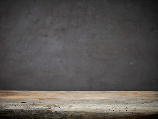 Image showing wooden table and grey wall