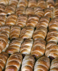 Image showing Sausages baked in dough on the tray