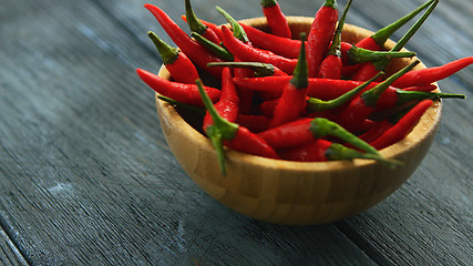 Image showing Wooden bowl full of chili pepper