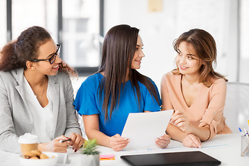 Image showing businesswomen discussing papers at office