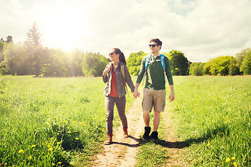 Image showing happy couple with backpacks hiking outdoors