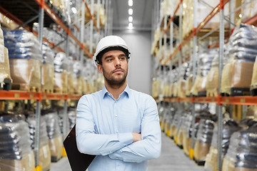 Image showing businessman in helmet at warehouse