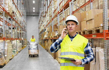 Image showing businessman calling on smartphone at warehouse