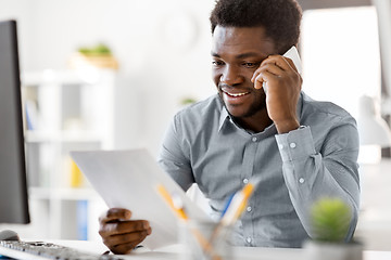 Image showing businessman calling on smartphone at office