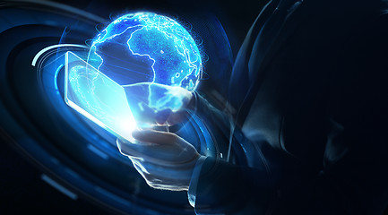 Image showing businessman with tablet pc and earth hologram