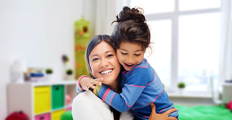 Image showing happy mother and daughter hugging at home