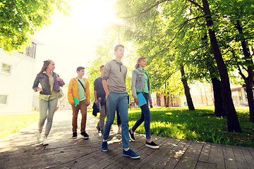 Image showing group of happy teenage students walking outdoors