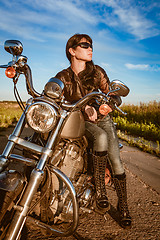 Image showing Biker girl sitting on motorcycle