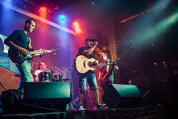 Image showing Band performs on stage in a nightclub