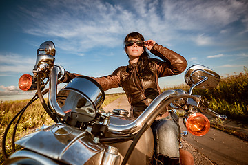 Image showing Biker girl sitting on motorcycle