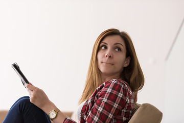 Image showing woman sitting on sofa with tablet computer