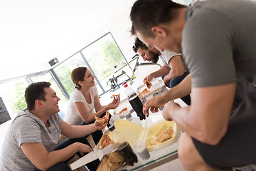 Image showing Pizza time a group of people