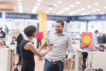 Image showing couple chooses shoes At Shoe Store