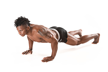 Image showing Muscular young man doing press-ups