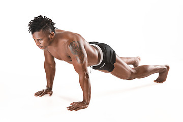 Image showing Muscular young man doing press-ups