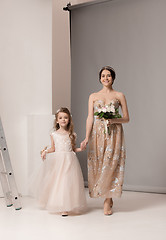 Image showing Little pretty girls with flowers dressed in wedding dresses