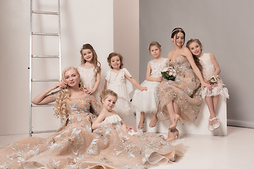 Image showing Little pretty girls with flowers dressed in wedding dresses