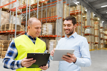 Image showing worker and businessman with tablet pc at warehouse