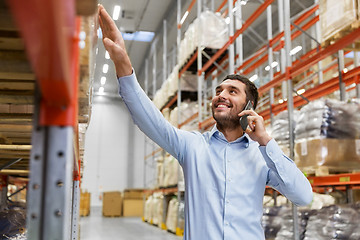 Image showing businessman calling on smartphone at warehouse