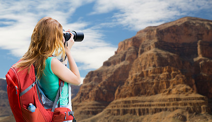 Image showing woman with backpack and camera at grand canyon