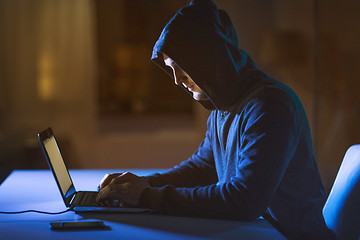 Image showing hacker using laptop computer for cyber attack