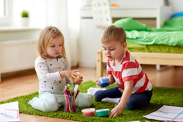 Image showing kids with modelling clay and crayons at home