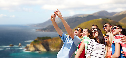 Image showing group of happy friends taking selfie by cell phone