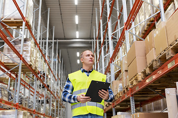 Image showing warehouse worker with clipboard in safety vest